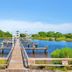 Pinnacle Port A-305 in Panama City Beach: wooden pier over calm blue water with green shoreline