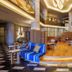 JR Hotel Clement Takamatsu lobby with curved stage seating, warm wood floors and modern chandelier