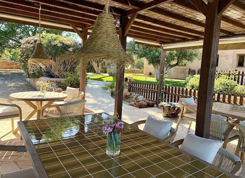 Agroturismo Sa Marina - Adults Only patio dining area with shaded tables and garden views in Santa Eulària des Riu