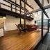 Rinn Shiki Juraku Kyoto loft-style guest room with wood beams, sofa, and tatami area