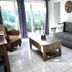 4145 By The Sea Inn & Suites in Lauderdale-by-the-Sea living room with sofa and sliding glass doors
