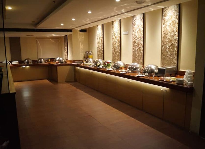 Hotel Winsar Park, Visakhapatnam: banquet buffet setup with covered serving dishes in a dining room