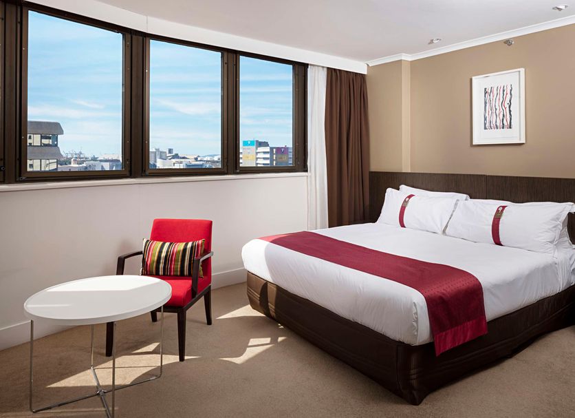 Hotel Grand Chancellor Townsville guest room with bed, seating area, and city views in Townsville