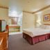 Vagabond Inn Hacienda Heights guest room with king bed, desk, and sitting area