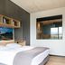 Downtown Apartments Mitte Berlin room with bed, built-in shelves, and city-view window