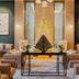 Waldorf Astoria Riviera Maya lobby with butterfly art, sofas and a lit decorative tree in Cancún