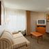 Candlewood Suites St. Joseph/Benton Harbor By IHG guest room in Stevensville with sofa, armchair and TV