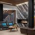 Delta Hotels by Marriott Thunder Bay lobby with fireplace, seating area and wood-paneled curved bench