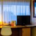 initial by balladins La Roche-sur-Yon guest room with desk, TV, lamp and window