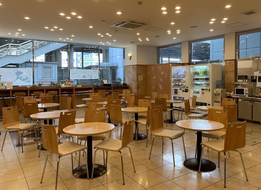 Toyoko Inn Shin-Yokohama Ekimae Shinkan dining area with round tables and chairs in Yokohama