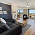 Royal Palm Resort in Palm Beach living room with balcony city view and TV