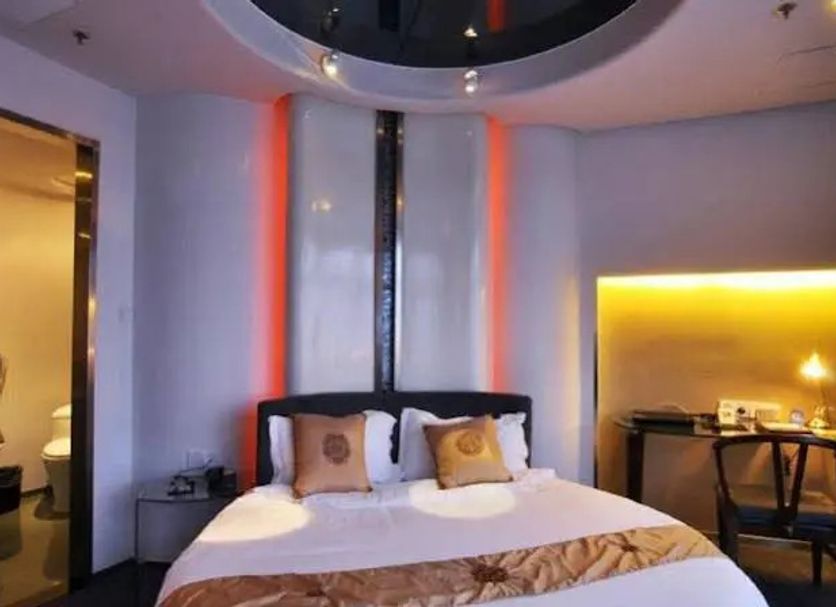 Dazhong Airport, Shanghai hotel room with a round bed, warm accent lighting and work desk
