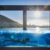 The Silo Hotel Cape Town rooftop pool with swimmer and mountain ocean views at sunset