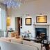 Casa Brenna Tosatto Art Experience in Lenno: elegant lounge with fireplace, chandelier and seating area
