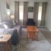 Evening Shade River Lodge & Cabins in Chimney Rock living room with sofa, coffee table, and armchair
