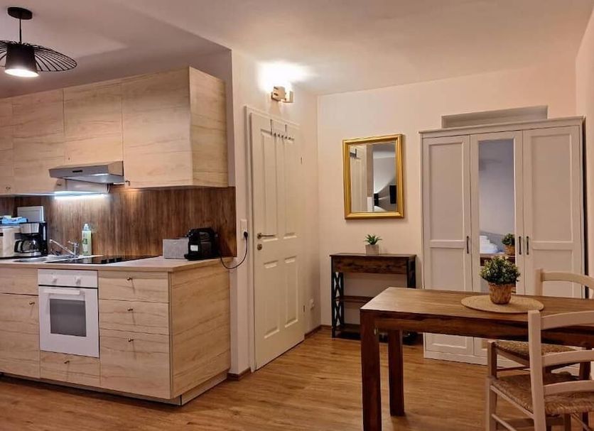 Dorf.Apart in Neustift im Stubaital with a compact kitchenette and dining table in a bright apartment room