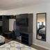Studio 6 Vicksburg, MS room with two beds, wall-mounted TV, desk, and full-length mirror