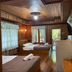 Sri Phairin Resort in Chanthaburi guest room with two beds, wood-paneled walls, and balcony doors