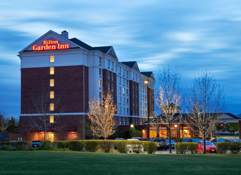 Hilton Garden Inn Hoffman Estates exterior at dusk with illuminated sign and parking lot