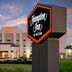 Hampton Inn Junction City exterior at dusk with illuminated sign and hotel facade