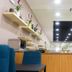 Residencial Lar do Areeiro dining area in Lisbon with blue chairs, buffet shelves, and wall-mounted TV