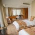 Shangmao International Hotel in Nanjing guest room with two beds, desk, and window seating