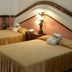 Canadian Resort Huatulco room in La Crucecita with two twin beds and bedside lamp