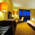 Vila Gale Coimbra hotel room in Coimbra with twin beds and a city-view window at night