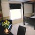The Globe Inn Tiverton four-poster bed in a guest room with seating and window light