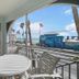Bridgewalk, a Landmark Resort balcony with table, ocean view, and palm-lined street in Bradenton Beach