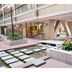 Tokyo Buc Nakagin in Tokyo, courtyard with stepping stones, pond and covered hotel entrance