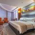 Yichang Guobin Bandao Hotel room with king bed, seating area and floor-to-ceiling window in Yichang