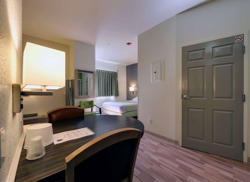 Studio 6 Toronto Mississauga room with desk, bed and doorway in Mississauga