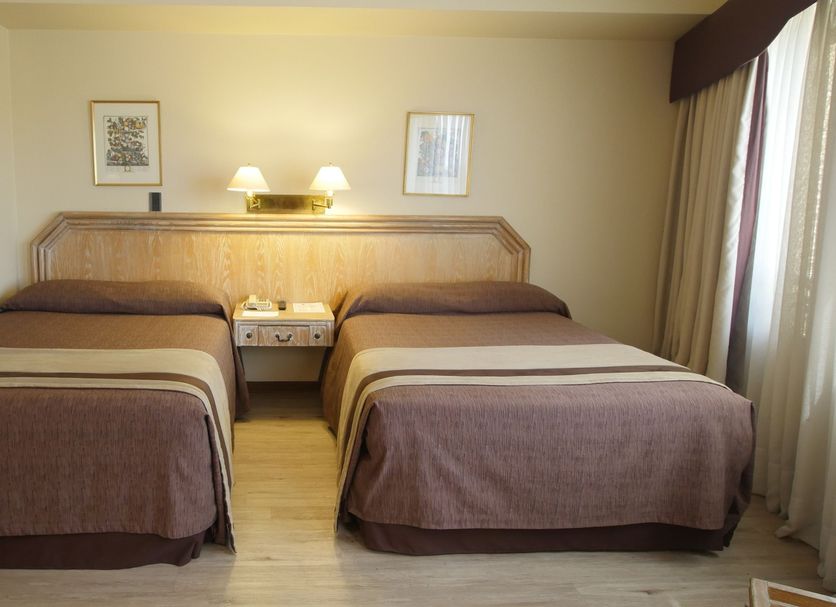 Hotel Diego de Almagro Santiago Centro guest room with two twin beds and bedside lamp in Santiago