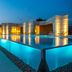 D-Resort Sibenik, Šibenik: illuminated rooftop infinity pool with waterfront views at dusk