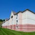 Sonesta Simply Suites Pittsburgh Airport in Pittsburgh, exterior of a pink-and-white hotel building