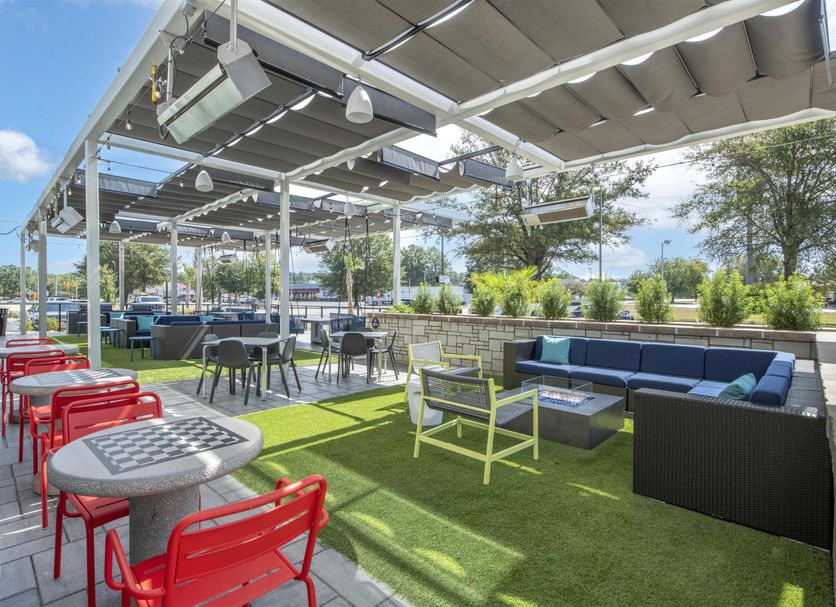 Outdoor rooftop-style lounge at Tru by Hilton Lumberton with seating and artificial turf
