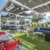 Outdoor rooftop-style lounge at Tru by Hilton Lumberton with seating and artificial turf