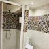 Pension Aduar in Marbella bathroom with shower, toilet, and patterned tile accents