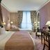 Le Dokhan's, Paris Arc de Triomphe, a Tribute Portfolio Hotel guest room with twin beds and tall windows
