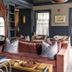 The Nantucket Hotel & Resort lounge with velvet sofa, ornate mirror, and shelving in Nantucket