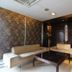 Hotel Waves, Delhi Airport lounge seating area with sofas, coffee table, and bookshelf in New Delhi