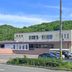 Hotel Sun Abashiri in Abashiri exterior with forested hillside backdrop and roadside view