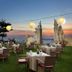 Discovery Kartika Plaza Hotel in Kuta: beachfront lawn dining with lanterns and sunset ocean view