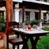 La Ermita de Santa Lucia in Antigua courtyard with table, chairs, greenery and colonial-style columns