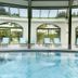 Das Alpenhaus Gasteinertal in Bad Hofgastein indoor pool with lounge chairs and garden views