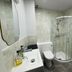 New Wilmington Hotel Eastbourne bathroom with glass corner shower, toilet and sink
