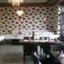 Europa Kehl Hotel dining room in Kehl with chandeliers, patterned wallpaper and set tables
