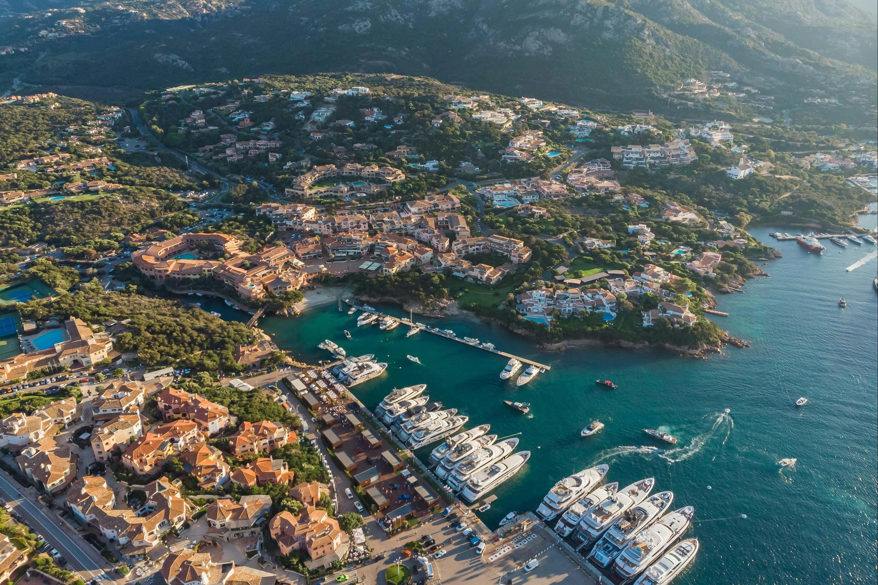 Aerial view of Cervo Hotel, Costa Smeralda Resort in Porto Cervo overlooking a marina and yachts