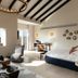 Gordonia Ma'ale Hahamisha guest room with bed, seating area, and mountain-view window